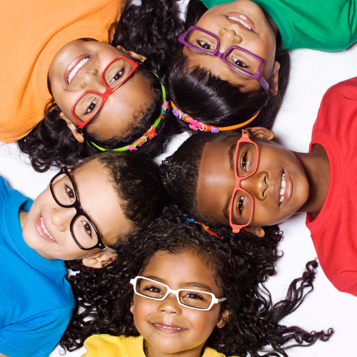 five children laying in a circle wearing glasses looking up at the camera
